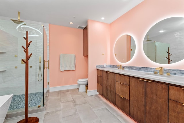 1 Waterway Ct Unit 4B, The Woodlands, TX 77380 - full bathroom with a shower stall, baseboards, double vanity, toilet, and recessed lighting