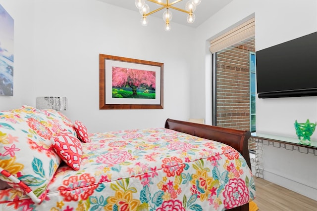 1 Waterway Ct Unit 4B, The Woodlands, TX 77380 - bedroom featuring a chandelier and wood finished floors