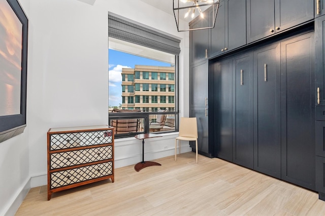 1 Waterway Ct Unit 4B, The Woodlands, TX 77380 - mudroom featuring light wood-style flooring and a chandelier