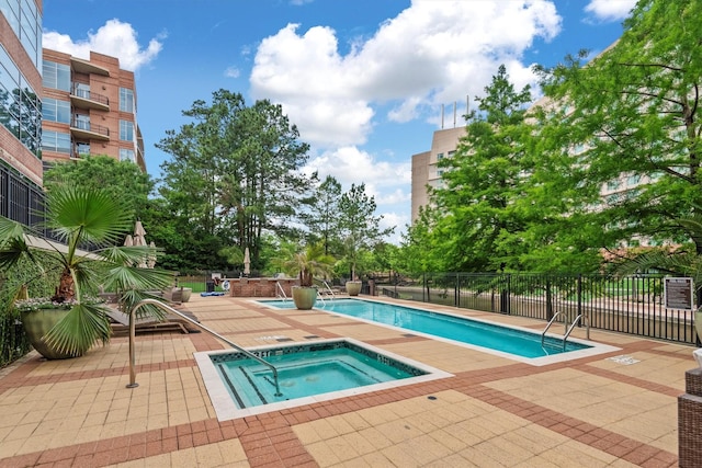 1 Waterway Ct Unit 4B, The Woodlands, TX 77380 - community pool with a hot tub, a patio, and fence