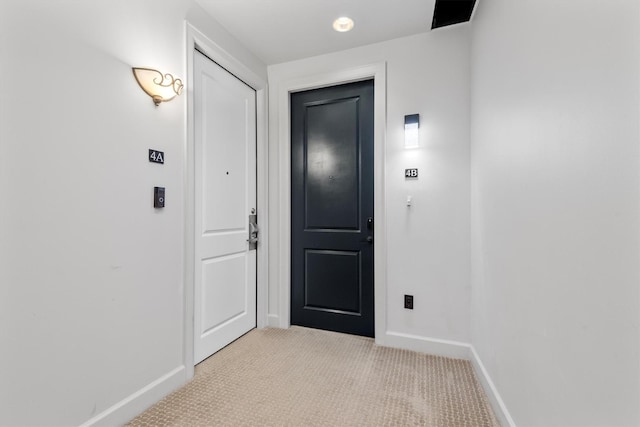 1 Waterway Ct Unit 4B, The Woodlands, TX 77380 - corridor featuring baseboards and light colored carpet