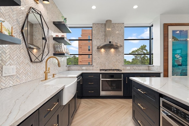 1 Waterway Ct Unit 4B, The Woodlands, TX 77380 - kitchen with appliances with stainless steel finishes, open shelves, wall chimney range hood, a sink, and recessed lighting