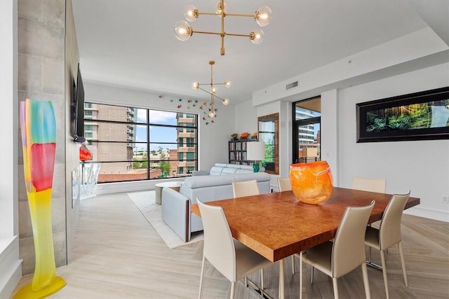 1 Waterway Ct Unit 4B, The Woodlands, TX 77380 - dining space with a chandelier and plenty of natural light