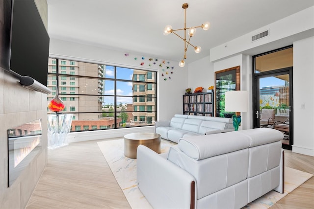 1 Waterway Ct Unit 4B, The Woodlands, TX 77380 - living area with healthy amount of natural light, a chandelier, and wood finished floors