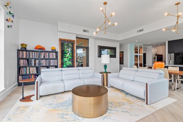 1 Waterway Ct Unit 4B, The Woodlands, TX 77380 - living room with a chandelier and light wood-style flooring