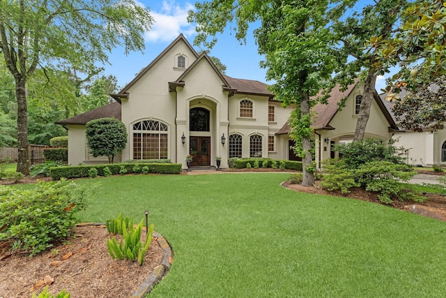 11 Freestone Pl, The Woodlands, TX 77382 - french country style house with french doors and stucco siding