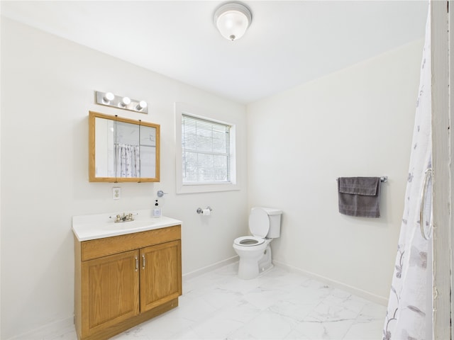 bathroom with marble finish flooring, toilet, baseboards, vanity, and a shower with curtain