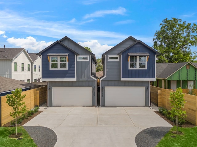 1307 Amundsen St N, Houston, TX 77009 - view of front of home with a garage, driveway, and board and batten siding