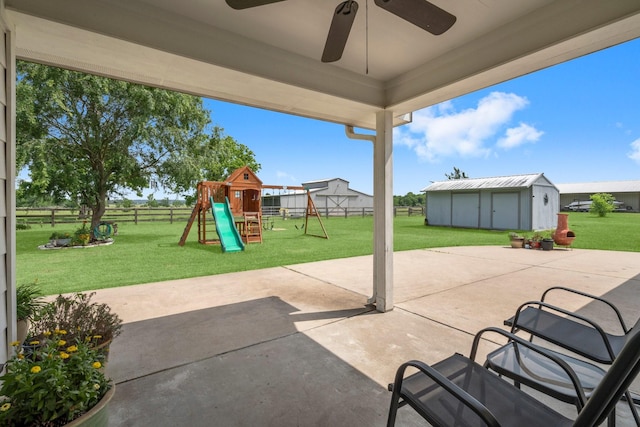 34334 Howell Rd, Waller, TX 77484 - view of patio / terrace with a playground, ceiling fan, and an outbuilding