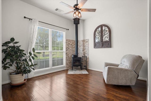 34334 Howell Rd, Waller, TX 77484 - living area with a wood stove, wood finished floors, baseboards, and ceiling fan