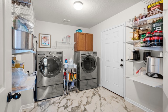 34334 Howell Rd, Waller, TX 77484 - washroom with independent washer and dryer, cabinet space, light marble finish flooring, a textured ceiling, and baseboards