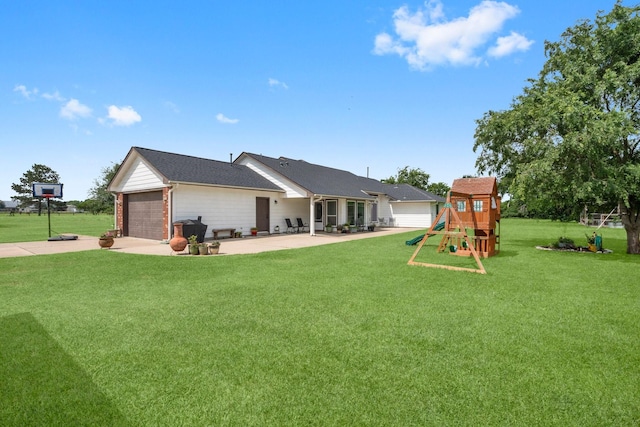 34334 Howell Rd, Waller, TX 77484 - rear view of house with a playground, driveway, a lawn, a garage, and a patio area