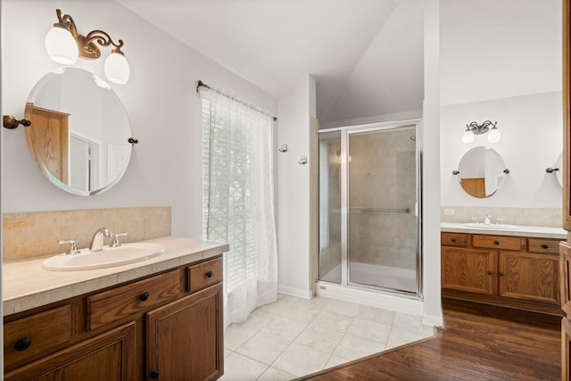 34334 Howell Rd, Waller, TX 77484 - bathroom with a shower stall, two vanities, lofted ceiling, and decorative backsplash