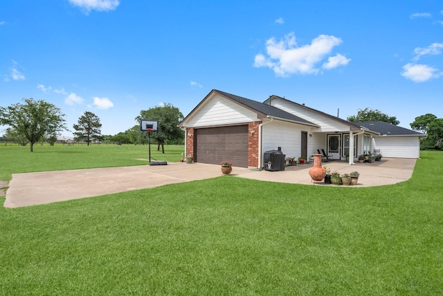 34334 Howell Rd, Waller, TX 77484 - view of front facade featuring a front lawn, concrete driveway, a garage, and brick siding