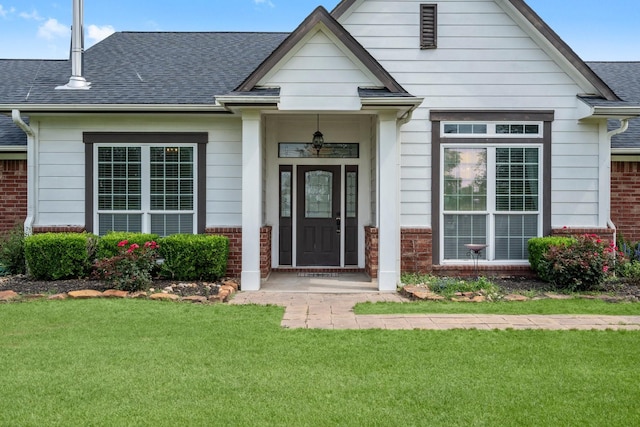 34334 Howell Rd, Waller, TX 77484 - view of front of house featuring brick siding, a front yard, and a shingled roof