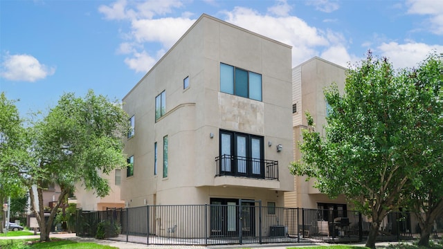 view of building exterior with a fenced front yard and central AC unit