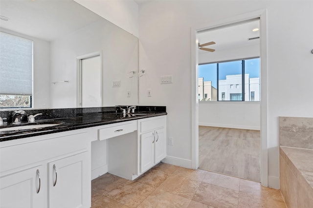 bathroom with double vanity, ceiling fan, and tile patterned flooring