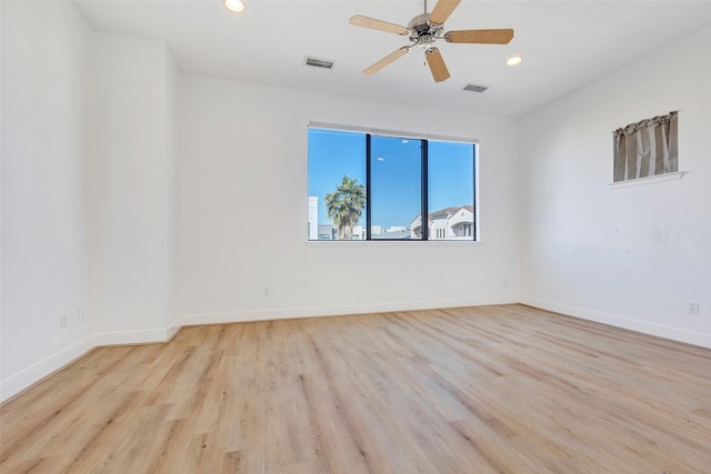 spare room featuring wood finished floors, recessed lighting, ceiling fan, and baseboards