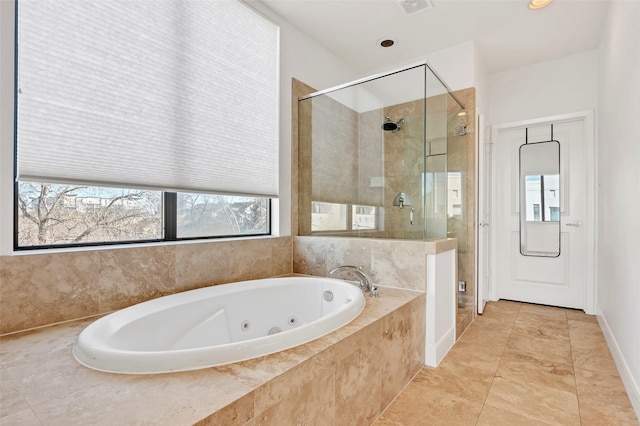 full bathroom featuring a shower stall and a tub with jets