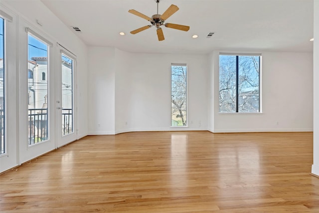 unfurnished room featuring plenty of natural light, light wood finished floors, and recessed lighting