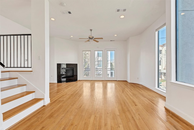 unfurnished living room featuring light wood finished floors, plenty of natural light, baseboards, ceiling fan, and recessed lighting