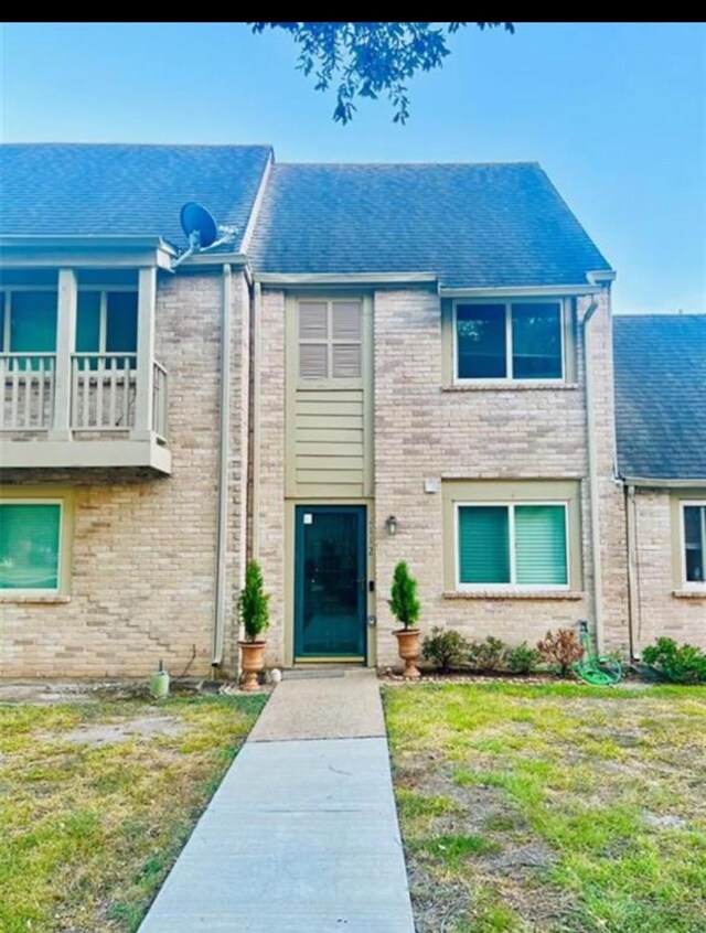 2112 Greenbriar Colony Dr, Houston, TX 77032 - view of front of property featuring brick siding, a front lawn, and roof with shingles