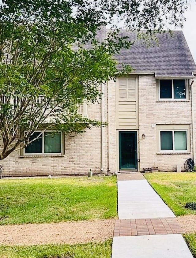2112 Greenbriar Colony Dr, Houston, TX 77032 - view of front facade with brick siding, roof with shingles, and a front lawn