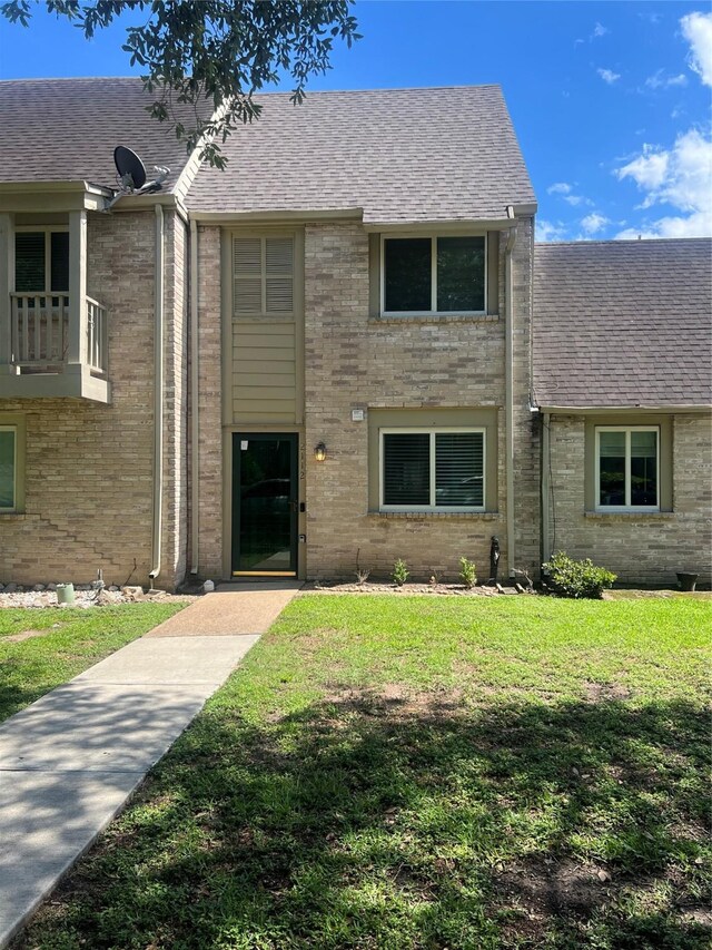 2112 Greenbriar Colony Dr, Houston, TX 77032 - townhome / multi-family property featuring a shingled roof and a front yard