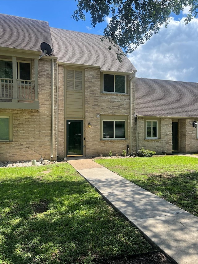 2112 Greenbriar Colony Dr, Houston, TX 77032 - view of front of property featuring a shingled roof, a front yard, and brick siding