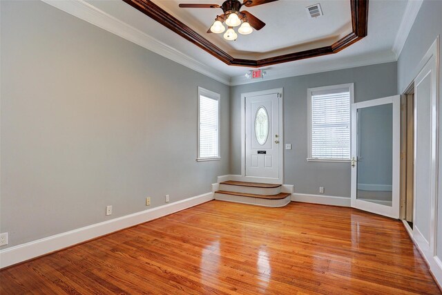 2709 Blodgett St, Houston, TX 77004 - entryway featuring crown molding, plenty of natural light, a ceiling fan, light wood-type flooring, and a tray ceiling