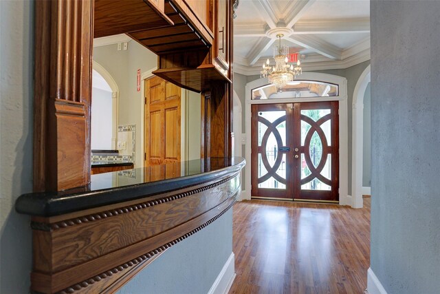 2709 Blodgett St, Houston, TX 77004 - entryway with arched walkways, a chandelier, ornamental molding, wood finished floors, and baseboards