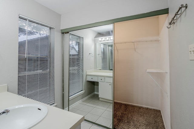 12210 Innsbruk Ct, Houston, TX 77066 - bathroom with vanity, tile patterned floors, and a walk in closet