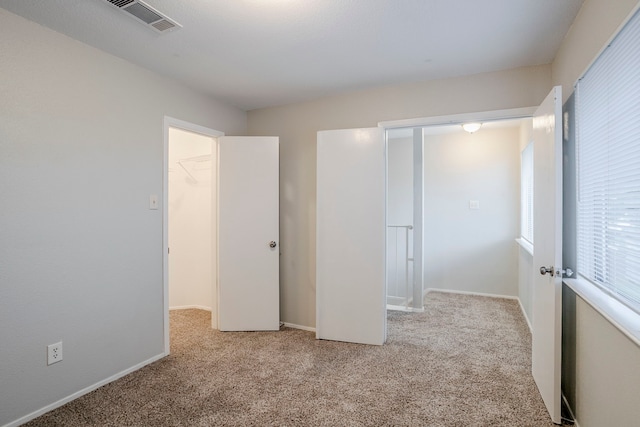 12210 Innsbruk Ct, Houston, TX 77066 - unfurnished bedroom with carpet floors, a walk in closet, baseboards, and a closet