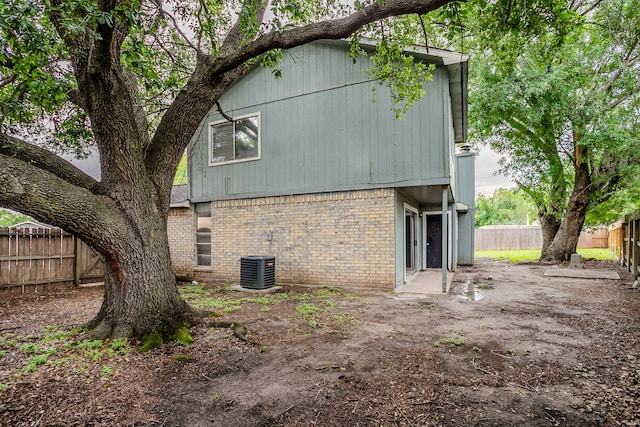 12210 Innsbruk Ct, Houston, TX 77066 - view of home's exterior with brick siding, central AC, and a fenced backyard