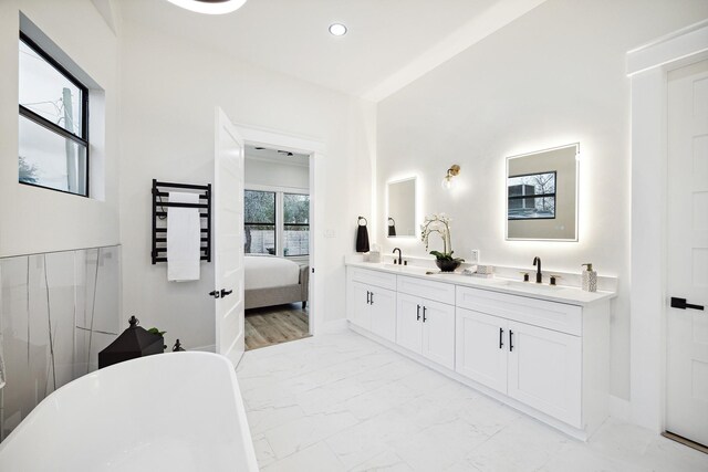 2611 Morrison St, Houston, TX 77009 - full bathroom featuring marble finish flooring, a freestanding tub, double vanity, ensuite bath, and recessed lighting