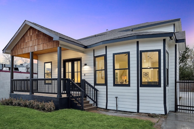 2611 Morrison St, Houston, TX 77009 - view of front facade featuring covered porch, a front yard, and roof with shingles