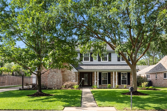 18007 Oakworth Dr, Houston, TX 77084 - view of front of home featuring a gate, brick siding, and a porch