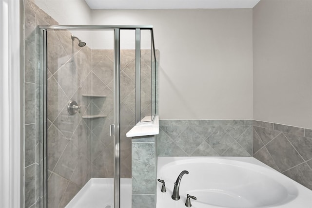 full bathroom featuring a garden tub and a shower stall