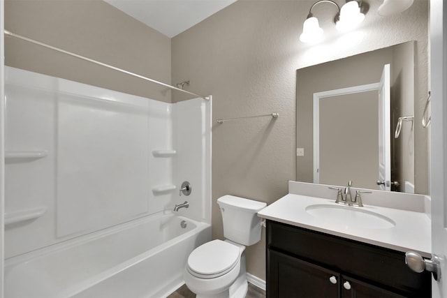 bathroom with toilet, vanity, and shower / washtub combination
