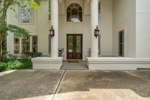 2 Argonne Pl, The Woodlands, TX 77382 - view of exterior entry featuring french doors and stucco siding