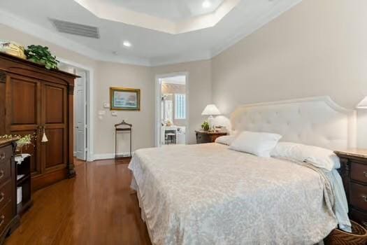 2 Argonne Pl, The Woodlands, TX 77382 - bedroom featuring dark wood-style floors, recessed lighting, a raised ceiling, and baseboards