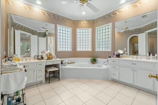 2 Argonne Pl, The Woodlands, TX 77382 - bathroom featuring ceiling fan, tile patterned flooring, a garden tub, vanity, and recessed lighting