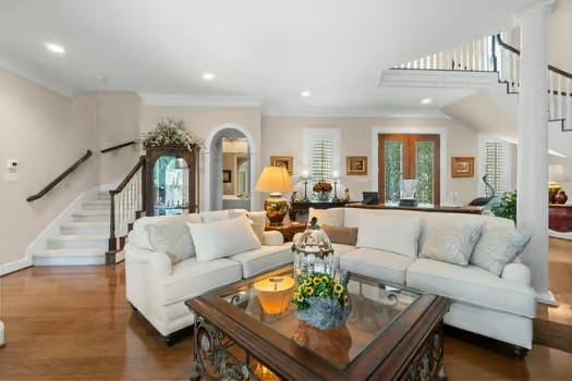 2 Argonne Pl, The Woodlands, TX 77382 - living area featuring stairs, wood finished floors, recessed lighting, crown molding, and baseboards