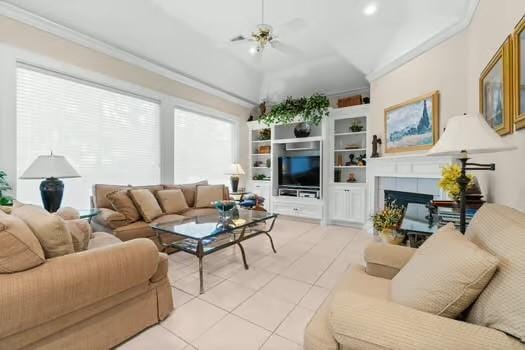 2 Argonne Pl, The Woodlands, TX 77382 - tiled living room with ornamental molding, a fireplace, a ceiling fan, recessed lighting, and lofted ceiling