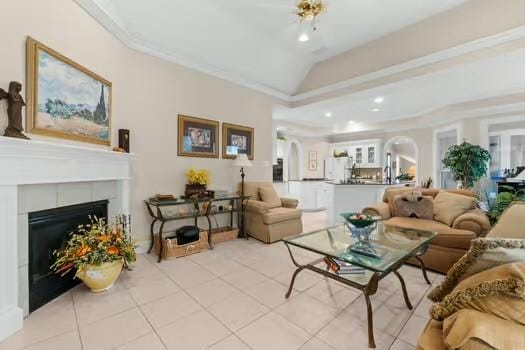 2 Argonne Pl, The Woodlands, TX 77382 - living room featuring arched walkways, recessed lighting, light tile patterned floors, a fireplace, and lofted ceiling
