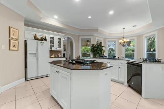 2 Argonne Pl, The Woodlands, TX 77382 - kitchen with white refrigerator with ice dispenser, a raised ceiling, dishwasher, stainless steel gas cooktop, and dark countertops