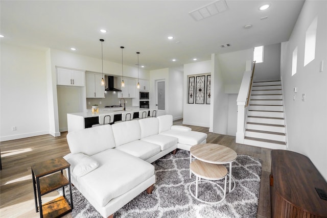 4111 Dreyfus St, Houston, TX 77021 - living room featuring wood finished floors, baseboards, stairs, and recessed lighting