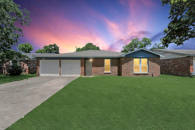 ranch-style house featuring concrete driveway, a garage, a front lawn, and brick siding