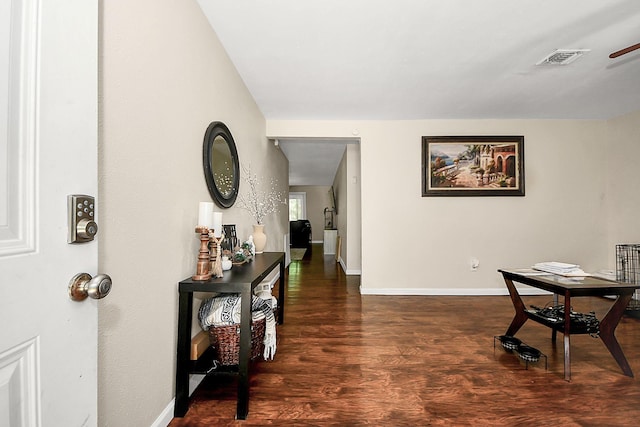 hall with wood finished floors and baseboards