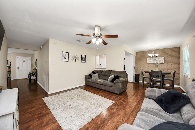 living room featuring a chandelier, a ceiling fan, dark wood-type flooring, and baseboards